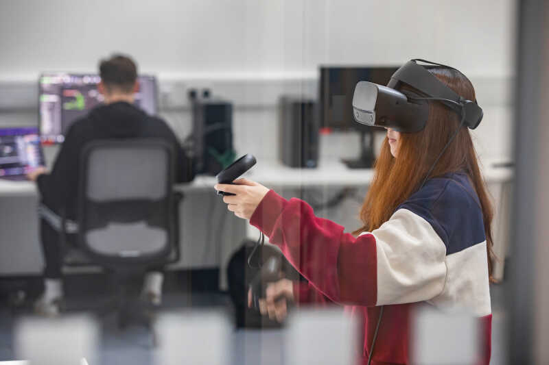 A woman uses a VR headset