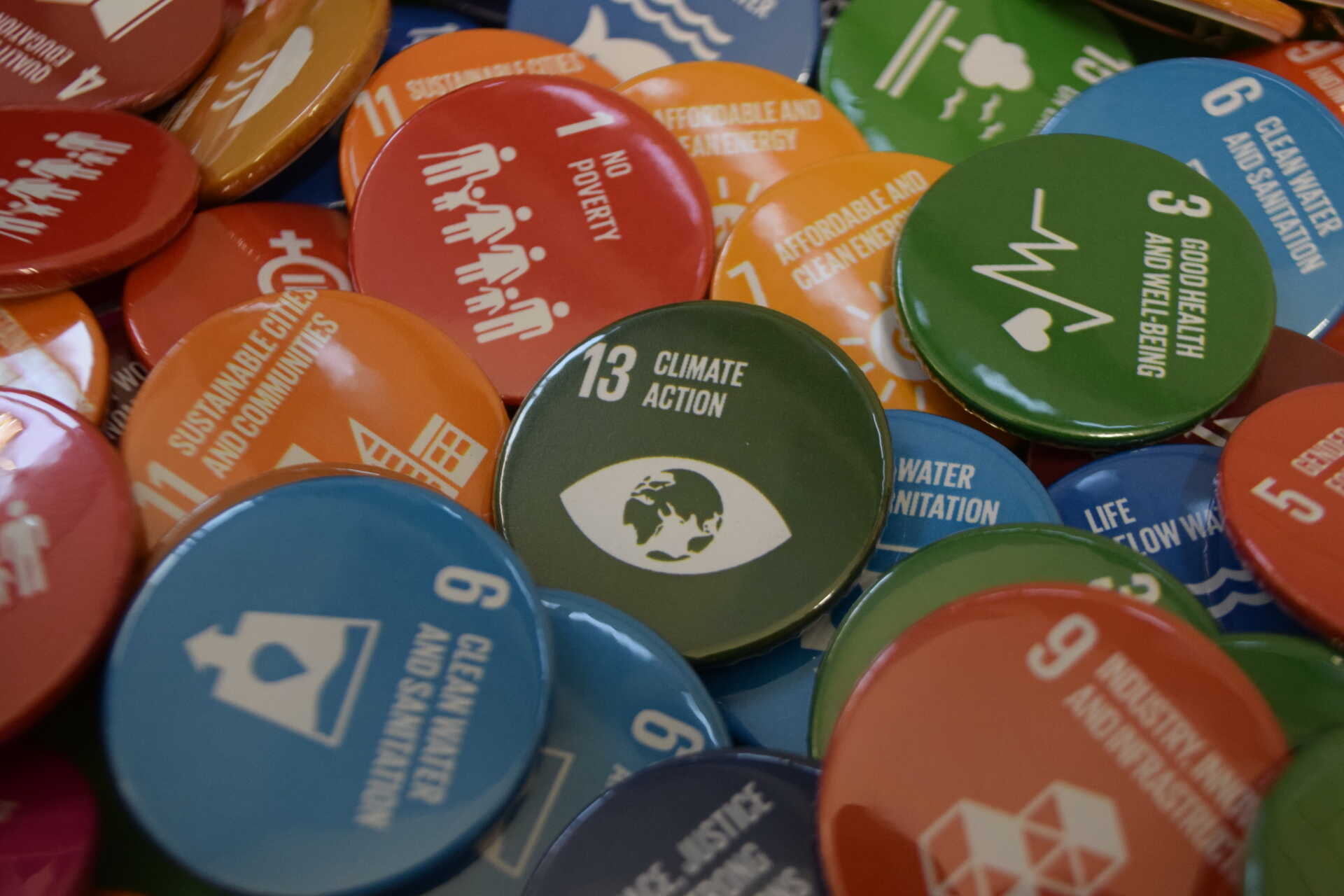 A collection of badges of different colours representing the United Nation's Sustainable Development Goals