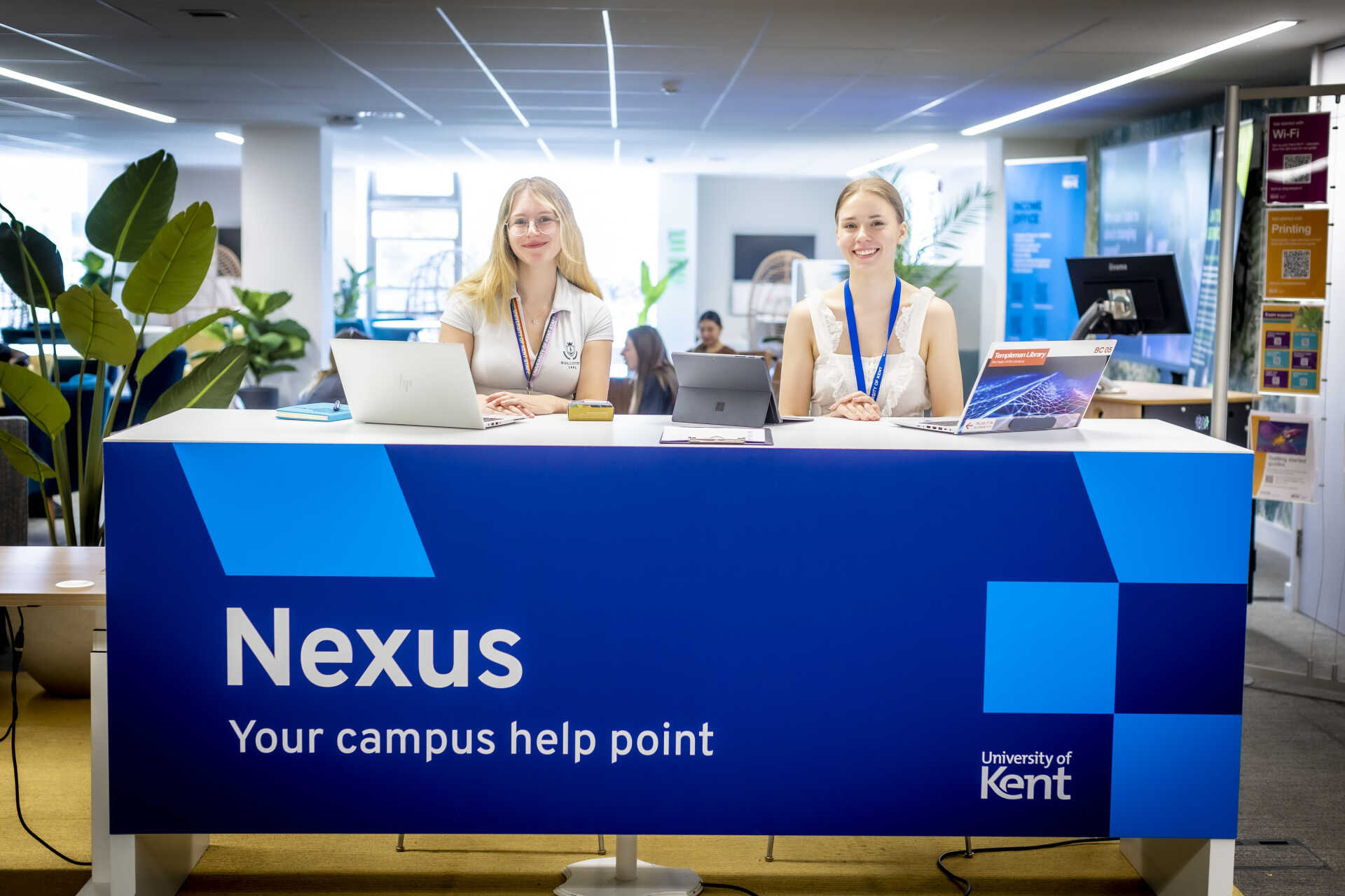 Nexus staff smiling at Nexus Welcome desk