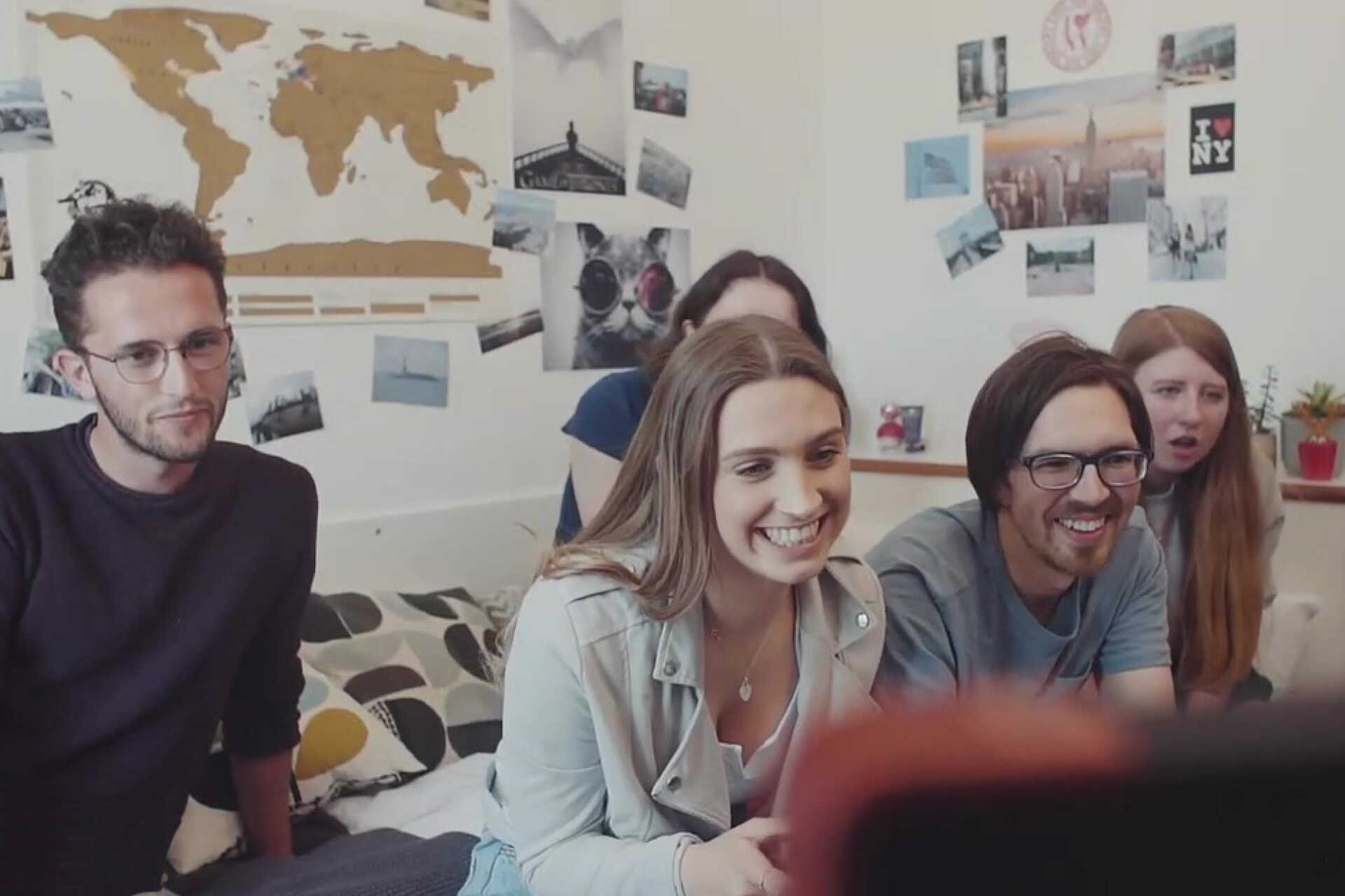 Group of students in bedroom playing video game