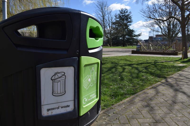 A duel refuse and recycling bin with the Canterbury campus in the background